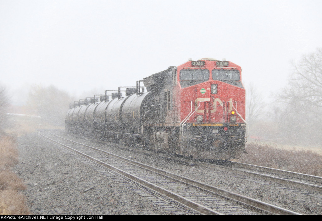 CN 3055 disappears in to the snow as U756 heads away